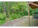 Backyard featuring a wooden deck and lush green trees, with an air conditioning unit visible at 3 Fairway Nw Dr, Kennesaw, GA 30144