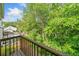 Balcony view overlooking lush greenery and a tranquil wooded area with a bright blue sky at 3 Fairway Nw Dr, Kennesaw, GA 30144