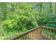 Balcony view overlooking a lush wooded area filled with mature trees and green foliage at 3 Fairway Nw Dr, Kennesaw, GA 30144