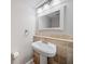 Cozy bathroom with pedestal sink, decorative mirror, and tile accents at 3 Fairway Nw Dr, Kennesaw, GA 30144
