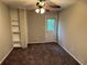 Bedroom featuring carpeted floors, built-in bookcase, and door to the exterior at 3 Fairway Nw Dr, Kennesaw, GA 30144