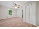 Bedroom with a closet, carpeted floors, ceiling fan, and natural light from the exterior window at 3 Fairway Nw Dr, Kennesaw, GA 30144