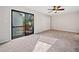 Bedroom featuring a sliding glass door with balcony access, neutral carpeting, and a ceiling fan at 3 Fairway Nw Dr, Kennesaw, GA 30144
