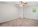 Bedroom featuring carpeted flooring, a ceiling fan, and built-in shelving beside the door to the outside at 3 Fairway Nw Dr, Kennesaw, GA 30144