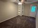 Bedroom with neutral walls, carpet, ceiling fan, built in shelves, and a windowed door at 3 Fairway Nw Dr, Kennesaw, GA 30144