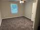 Neutral bedroom featuring carpeted floors and a window letting in natural light at 3 Fairway Nw Dr, Kennesaw, GA 30144