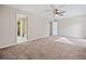 Spacious bedroom with neutral carpeting, a ceiling fan, and an ensuite bathroom at 3 Fairway Nw Dr, Kennesaw, GA 30144