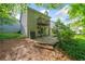 Exterior view of the home with a wooden deck, lush trees, and an air conditioning unit visible at 3 Fairway Nw Dr, Kennesaw, GA 30144