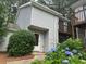 Charming home featuring a welcoming front door, white siding, and beautiful landscaping with blue hydrangeas at 3 Fairway Nw Dr, Kennesaw, GA 30144