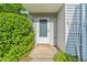 Inviting front entrance with well-kept greenery and neutral colored siding at 3 Fairway Nw Dr, Kennesaw, GA 30144