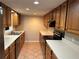 Galley kitchen features wood cabinets, laminate countertops, and stainless steel appliances at 3 Fairway Nw Dr, Kennesaw, GA 30144