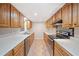 Well-lit kitchen with oak cabinets, stainless appliances, and neutral countertops at 3 Fairway Nw Dr, Kennesaw, GA 30144
