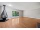 Bright living room with hardwood floors, a modern fireplace, and sliding glass doors to the outside at 3 Fairway Nw Dr, Kennesaw, GA 30144