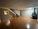 Open-concept living room featuring hardwood floors, fireplace, staircase, and views into the kitchen at 3 Fairway Nw Dr, Kennesaw, GA 30144