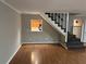 Inviting living room with hardwood floors, staircase, and view into the kitchen at 3 Fairway Nw Dr, Kennesaw, GA 30144