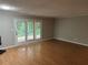 Open living room with hardwood floors, sliding glass doors, and neutral colored walls at 3 Fairway Nw Dr, Kennesaw, GA 30144
