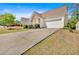 Wide driveway leading up to a charming home featuring stone accents and a two-car garage at 3321 Hampreston Nw Way, Kennesaw, GA 30144