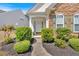 A charming home featuring a covered entryway with manicured landscaping at 3321 Hampreston Nw Way, Kennesaw, GA 30144