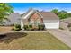 Charming home featuring stone accents, manicured landscaping, and a two-car garage at 3321 Hampreston Nw Way, Kennesaw, GA 30144