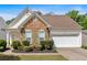 Charming home featuring stone accents, manicured landscaping, and a two-car garage at 3321 Hampreston Nw Way, Kennesaw, GA 30144