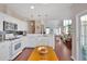 Charming kitchen with white cabinets, stainless appliances, and an open layout to the living room at 3321 Hampreston Nw Way, Kennesaw, GA 30144