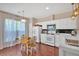 Inviting kitchen boasts modern appliances, white cabinets, and a cozy breakfast nook near windows at 3321 Hampreston Nw Way, Kennesaw, GA 30144