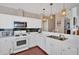 Bright kitchen features white cabinets, black backsplash, modern appliances, and stylish pendant lighting at 3321 Hampreston Nw Way, Kennesaw, GA 30144