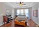 Relaxing main bedroom features a tray ceiling, hardwood floors, and ample natural light at 3321 Hampreston Nw Way, Kennesaw, GA 30144