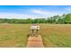 Vast grassy field with an informational sign and picnic pavilions in the background, ideal for outdoor gatherings and community events at 3321 Hampreston Nw Way, Kennesaw, GA 30144