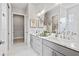 Modern bathroom featuring double sinks, marble countertops, and a walk-in closet, designed for convenience at 3543 Cedarvale Ct, Powder Springs, GA 30127