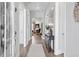 Inviting hallway that leads to a beautiful living room with a fireplace and hardwood floors at 3543 Cedarvale Ct, Powder Springs, GA 30127