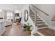 Bright living room with a fireplace, hardwood floors, and staircase with modern black accents at 3543 Cedarvale Ct, Powder Springs, GA 30127