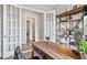 Stylish office with French doors, modern decor, and built-in shelving for a professional setting at 3543 Cedarvale Ct, Powder Springs, GA 30127
