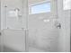 Luxurious shower with marble tiles, glass enclosure, and contemporary fixtures, creating a spa-like experience at 3543 Cedarvale Ct, Powder Springs, GA 30127
