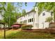 Spacious backyard featuring a deck, lush landscaping, basketball court and mature trees providing privacy at 1400 Squire Ln, Cumming, GA 30041