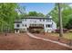 Backyard showcasing the two-story house with large deck, manicured yard and walkway at 1400 Squire Ln, Cumming, GA 30041