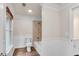 Well-lit bathroom featuring wood-look tile floors and a tub-shower combination at 1400 Squire Ln, Cumming, GA 30041