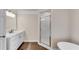 Elegant bathroom featuring a standalone tub and glass shower with a modern vanity at 1400 Squire Ln, Cumming, GA 30041