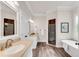 Bright bathroom boasts double vanity, soaking tub, and glass-enclosed shower at 1400 Squire Ln, Cumming, GA 30041