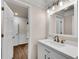 Clean bathroom with white cabinets, white countertop, and modern bronze fixtures at 1400 Squire Ln, Cumming, GA 30041