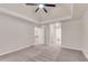 Spacious bedroom featuring a trey ceiling, neutral paint, and access to other rooms of the house at 1400 Squire Ln, Cumming, GA 30041