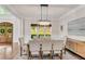 Stunning dining room with a chandelier, wood floors, and wainscoting at 1400 Squire Ln, Cumming, GA 30041