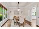 Elegant dining room with wood floors, large windows and modern chandelier at 1400 Squire Ln, Cumming, GA 30041