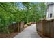 Gated driveway leading to the home, surrounded by lush greenery at 1400 Squire Ln, Cumming, GA 30041