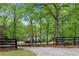 Charming property with a long driveway, lush trees, and a gated entrance at 1400 Squire Ln, Cumming, GA 30041