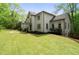 Elegant home with a beautifully manicured lawn and mature trees at 1400 Squire Ln, Cumming, GA 30041