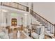 Bright foyer with staircase and wood double door entrance at 1400 Squire Ln, Cumming, GA 30041