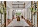Elegant foyer with hardwood floors, a striking staircase, and a view to the living area beyond at 1400 Squire Ln, Cumming, GA 30041