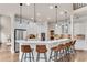 Bright kitchen with stainless steel appliances, white cabinets, pendant lights and a breakfast bar with seating at 1400 Squire Ln, Cumming, GA 30041
