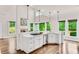 Open kitchen with white cabinets, island cooktop, and hardwood floors at 1400 Squire Ln, Cumming, GA 30041